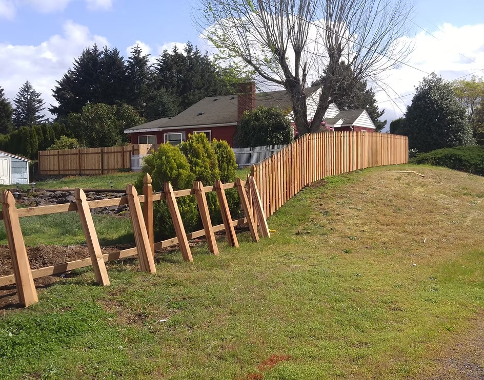Adam's crew installing a wood fence on a job site