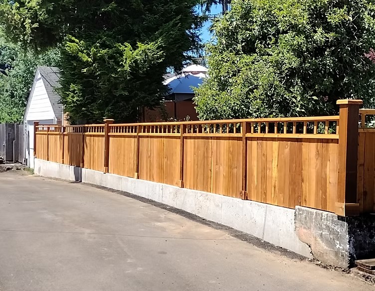Cedar wood fence with decorative top rail